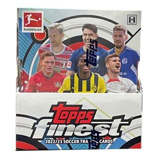 Feel the Finest of Bundesliga with the 2022-23 Topps Finest Hobby Box! Every box contains 2 autograph cards, guaranteeing double the international soccer stardom of Germany's greatest players. From Guardians to Young Talents, you'll be scoring big with the Bundesliga's Finest!  The collection consists of numerous base cards, as well as numbered parallels, and desirable rare autograph cards of Bundesliga Stars such as Jude Bellingham, Christopher Nkunku or Leroy Sane.