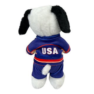 Plush dog wearing blue USA Olympic Team track suit